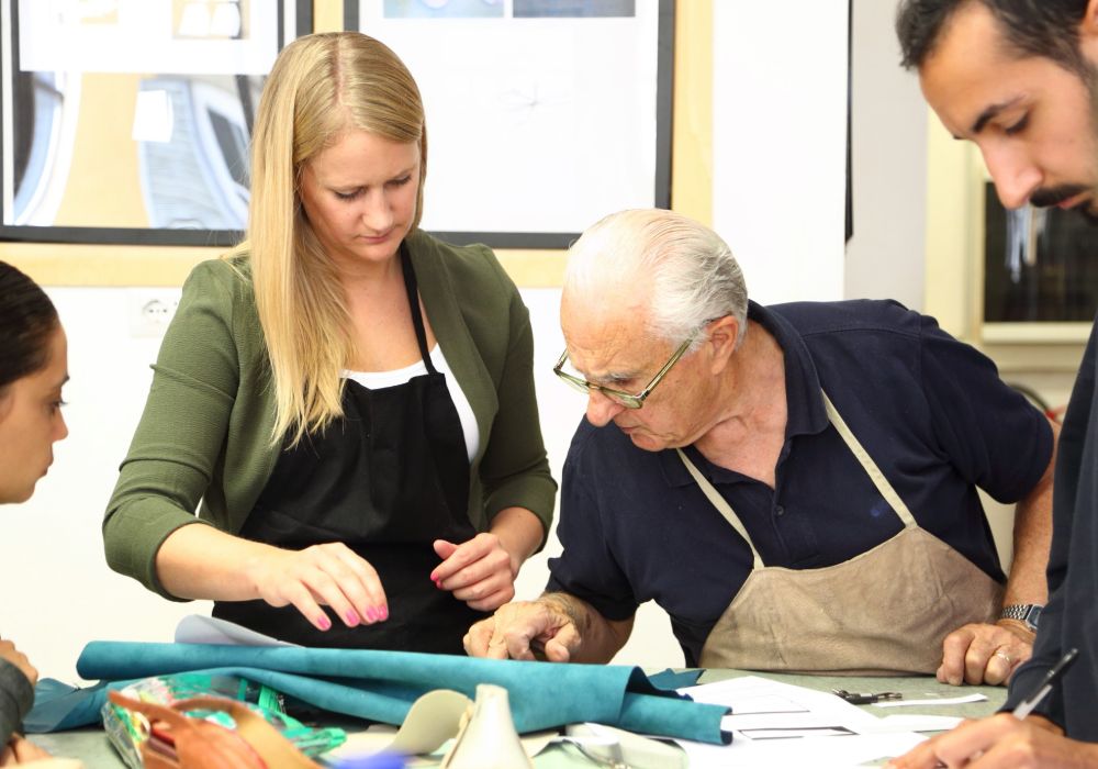 Students at Accademia Riaci in Italy collaborating on tailoring projects.