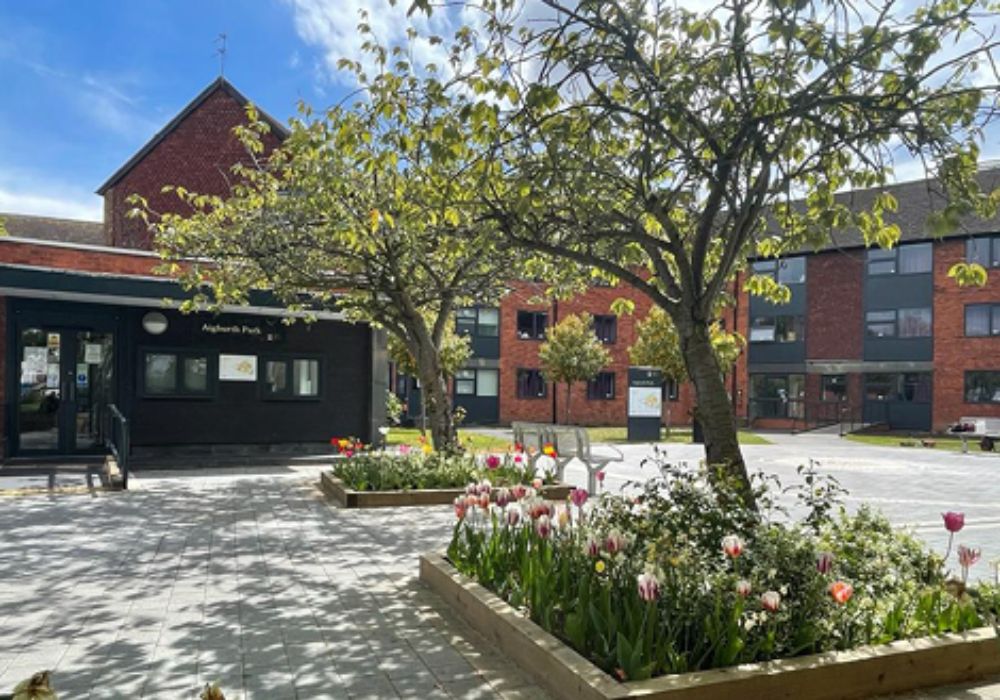 A sunny courtyard featuring a building.