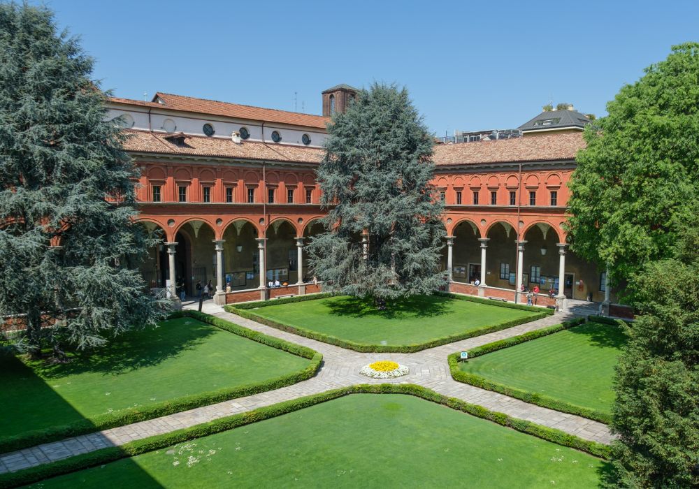 A peaceful courtyard featuring lush green grass and trees.