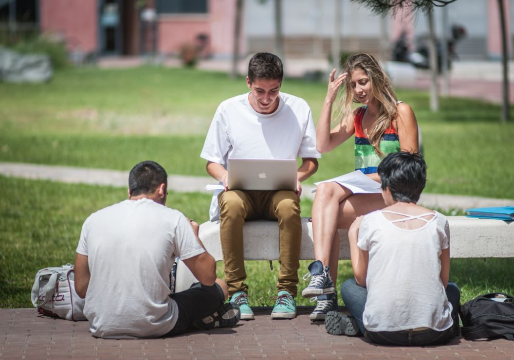 A group of students, engaged with their laptops.
