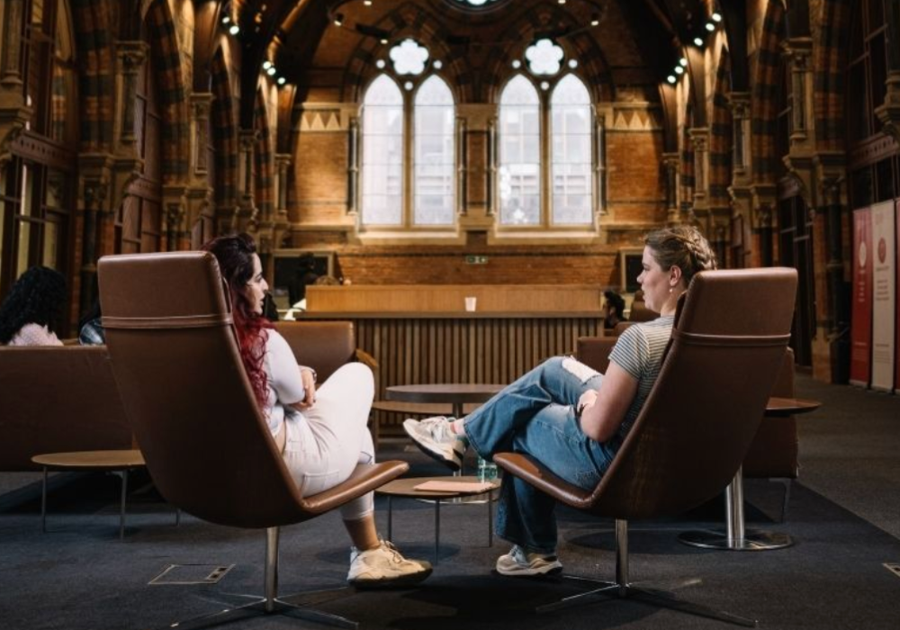 Two people sitting in chairs.
