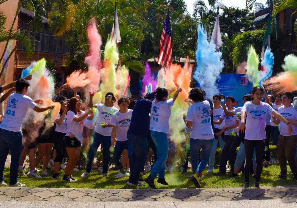 A group of students throwing colored powder in the air.